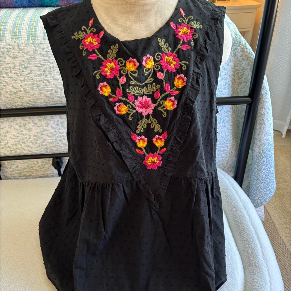 Black Sleeveless Ruffled, fully lined Blouse with beautiful embroidery.